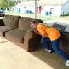 Photo by Cristin Parker
Good Samaritan President Mona Burford, who turns 70 in November, struggles to move a couch that was illegally dumped in the food loading zone at the Good Samaritan’s site in Rusk sometime during the evening of Sept. 10.