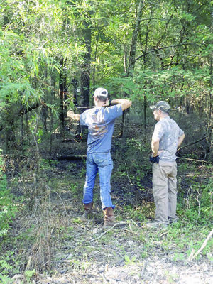 Courtesy Photo
William Hunt prepares to take a shot during the third annual bow shoot held by the Wells FFA Booster Club as David Seymore, owner of Seymore Outdoors in Wells an event sponsor watches on.