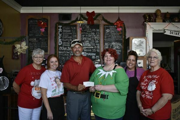 Photo by Josie Fox
Rusk Chamber of Commerce Vice President Mark Raiborn, center, accepts a $500 donation from the Daily Grind owner Rachel Loden recently. Also pictured, from far left are Daily Grind employees LaDonna Sparkman, Emily Duke, Billie Seeton and Karen Loden.
