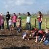 Photo by Rachel Galan
County AgriLife Agent Kim Benton, far left, leads local youth in potato planting in Snake Woman’s Garden earlier this spring.