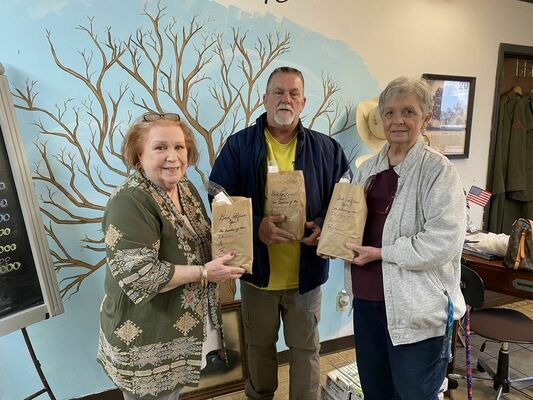 Major Thaddeus Beall Chapter NSDAR Chapter Corresponding Secretary Linda Huffaker (left) and Chapter Regent Linda Jones (right) deliver brown paper lunch bags of donated individual personal care supplies to Billy Bateman of the Highway 69 Mission in Jacksonville. 

Courtesy photo