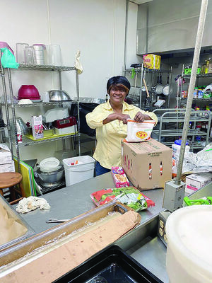 Courtesy photo
Sylvia Mae, sole owner and head chef of Jacksonville’s Sylvia Mae’s Soul Food Restaurant gets ready to start prepping for meal service at HOPE’s Community Kitchen recently.