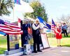 Singer Virginia Goforth (right) listens as program coordinator Ken McClure addresses the audience during Saturday's Veterans Day event held at Courthouse Square in Rusk. Courtesy photo