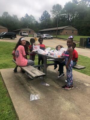 Rusk students enjoy a picnic after scoring their lunches.