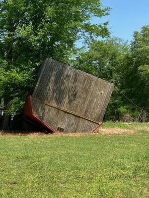 An outbuilding just of Texas Highway 21 remains in its final resting spot from two years before, when tornadoes struck the area.

Photo by John Hawkins