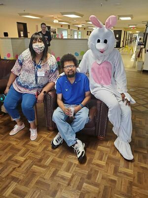 The Easter Bunny visits with residents and staff of Cherokee Trails in Rusk earlier this month.