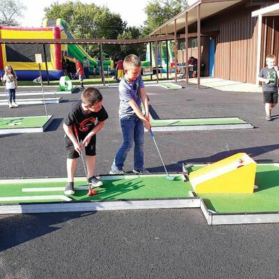 Photo by Jo Anne Embleton

Youths try their hand at putt-putt golf, on a course set up at Alto’s Hillside Baptist Church during a recent unity event at the church.