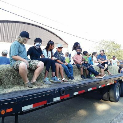 Photo by Jo Anne Embleton

 Attendees of all ages clamber aboard a trailer at the recent One Love Alto event, waiting for a hayride to begin. The ride was part of an afternoon celebration of unity in the southern Cherokee County City.